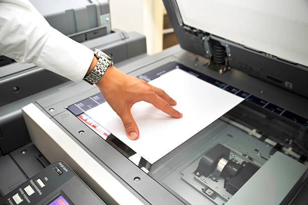 human hand using copier. Close-up picture with bright light