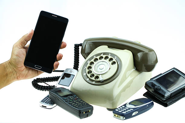 New smart phone with old telephone on white background. New communication technology.