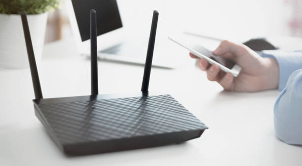 Wireless router or access point. Man using smartphone